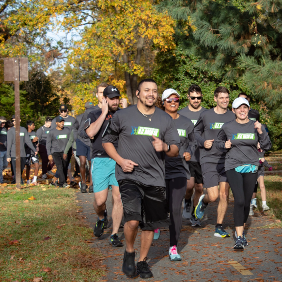 BNet giving back Group of people running on an outdoor trail for the Kids’ Chance Foundation 5K, showing BerkleyNet’s commitment to giving back and supporting opportunities for children of injured workers.