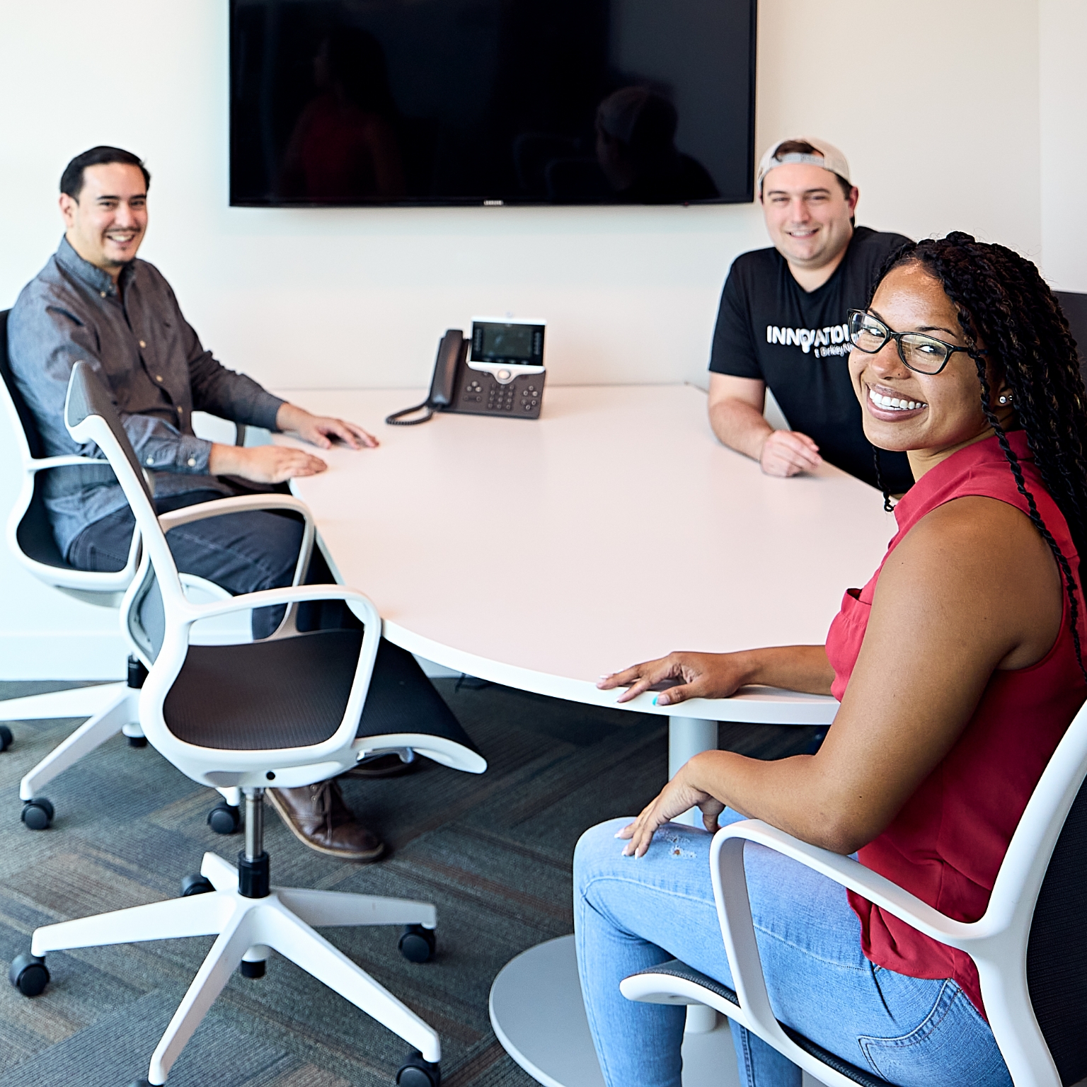 Berkley Net Insurance Policy Tools Smiling BerkleyNet workers compensation insurance team gathered around a conference table in an office.