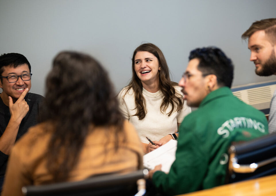Why do I need a premium audit? Group of BerkleyNet employees smiling in an office.