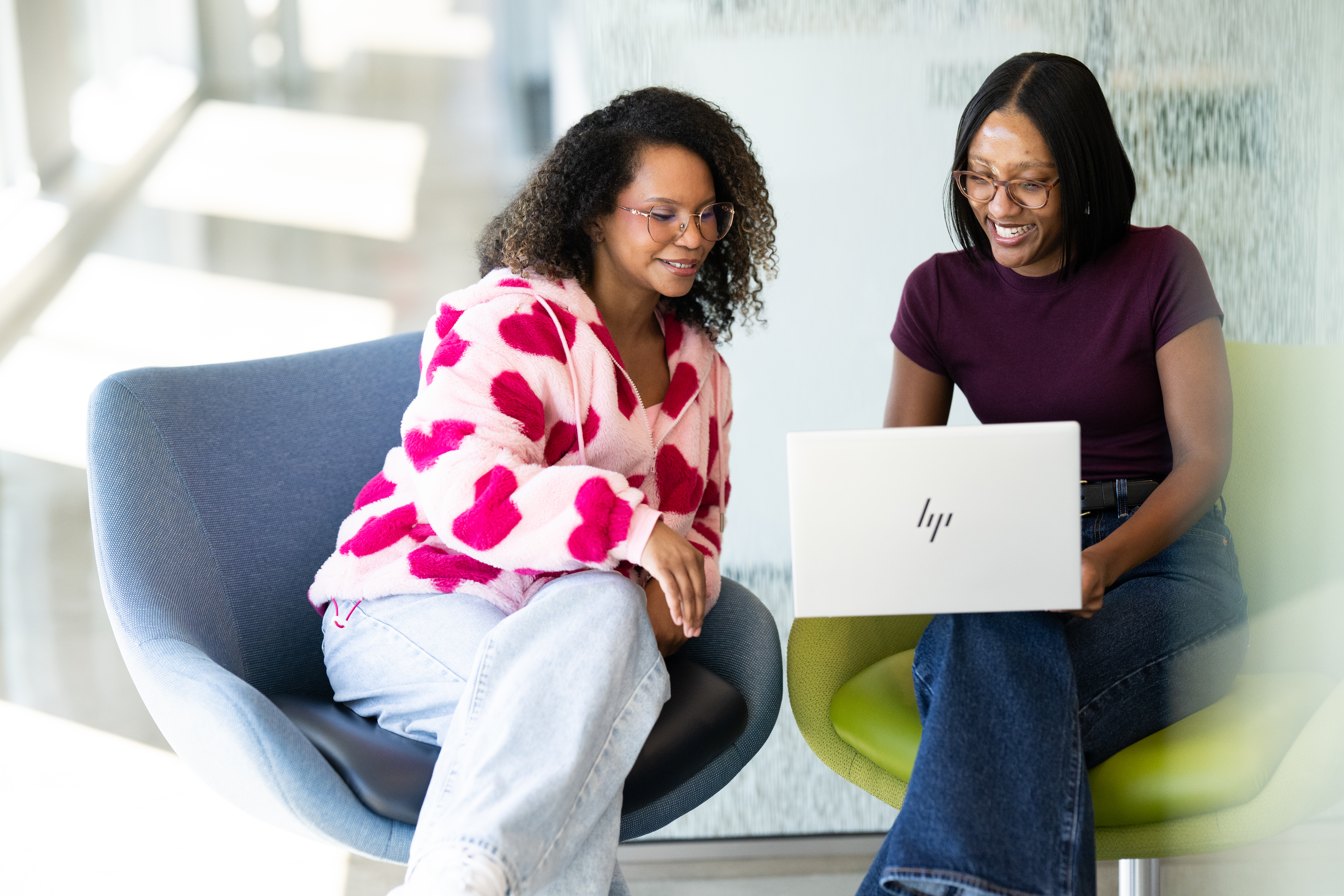 Four BerkleyNet employees sitting in a bright office space, a welcoming and professional team dedicated to fast and easy workers compensation insurance solutions. 